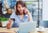 woman on phone checking five back balance
